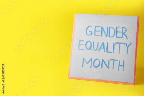 Card with phrase Gender Equality Month on yellow background, space for text