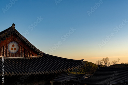 the glow of the sunset over the roof of the temple