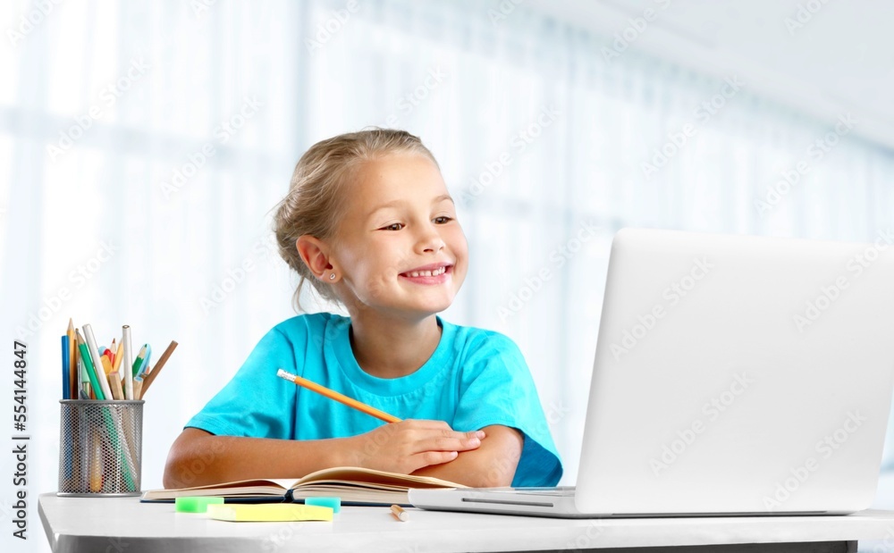Smiling small child do homework in room Smiling small child do homework in room