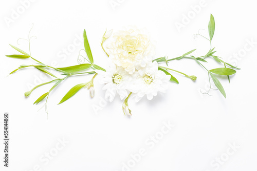 Delicate flower arrangement with flowers and leaves. Summer festive background. Copy space, flat lay. 