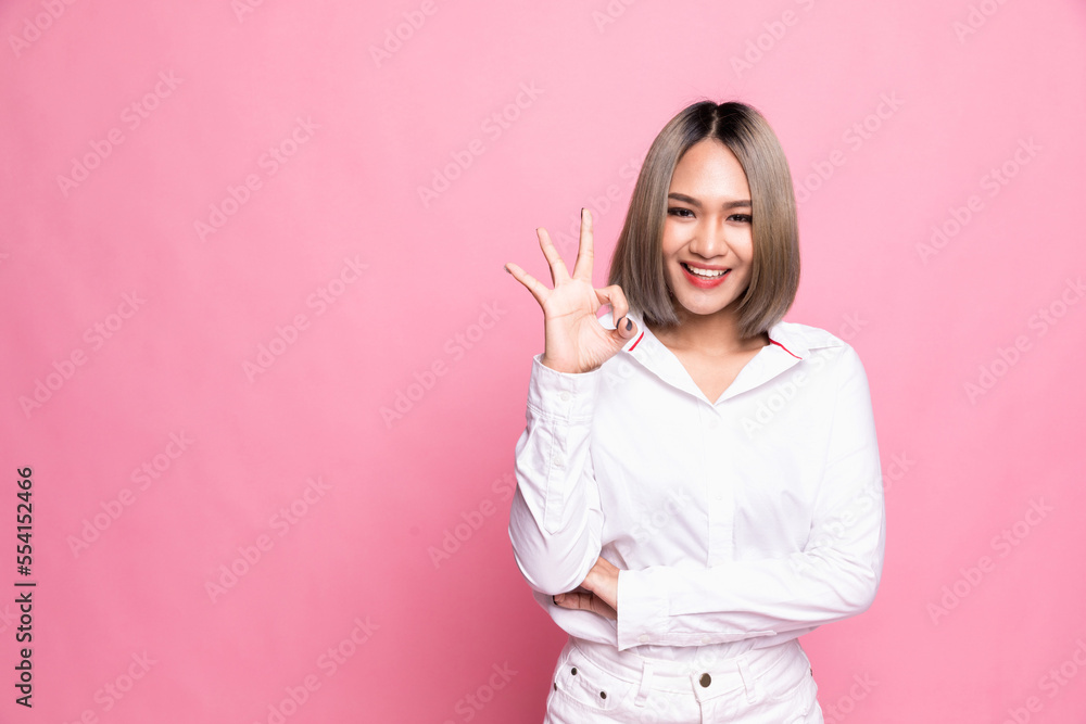 Happy Asian portrait beautiful cute young woman excited gesturing ok sign, studio shot isolated on pink background. Happy Asian portrait beautiful cute young woman excited gesturing ok sign, studio shot isolated on pink background.