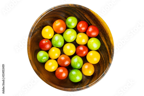 Top view of freshly harvested colorful organic cherry tomatoes in wooden plate isolated on white background with clipping path.
