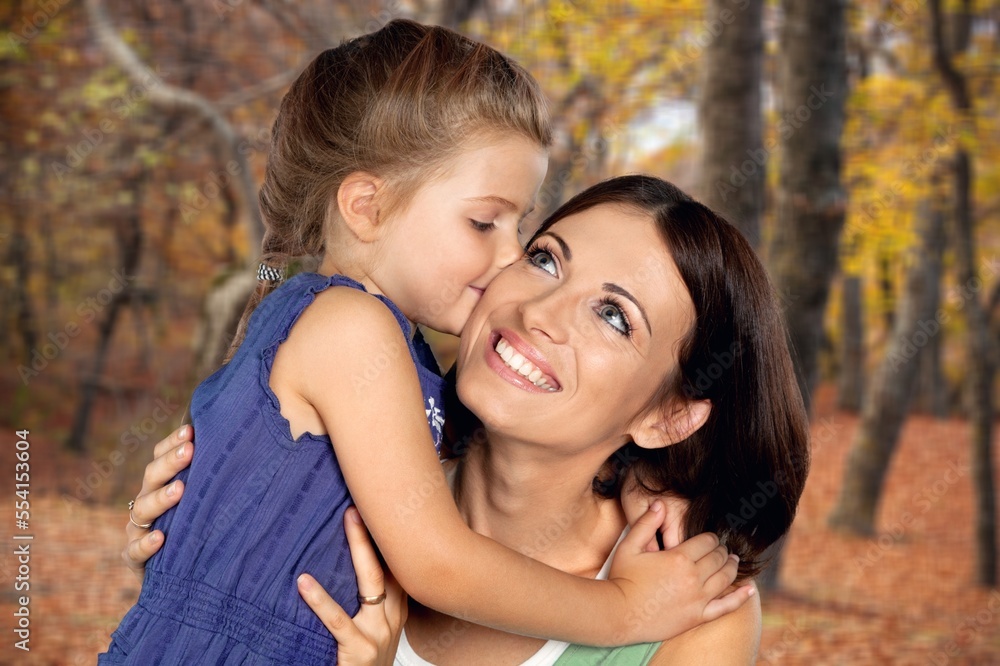 Obraz premium Happy young mother play with cute child in park