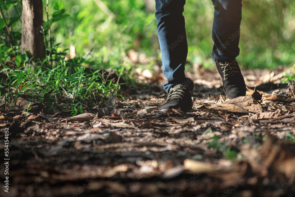 Trekker walking in the mountains, close up of the foot, low angle Trekker walking in the mountains, close up of the foot, low angle