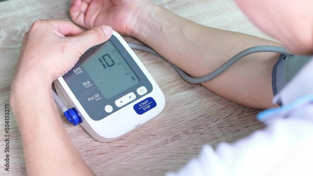 Man check blood pressure monitor and heart rate monitor with digital pressure gauge. Health care and Medical concept