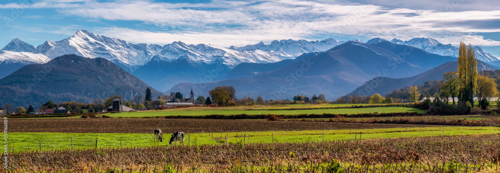Fototapeta premium Panorama of a farm and field at the base of the Pyrenees Mountains