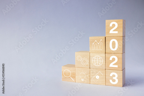 2023 business growing growth concept to success. woods block step with icon concept about business strategy, Action plan, Goal and target, hand stack, project, vision.