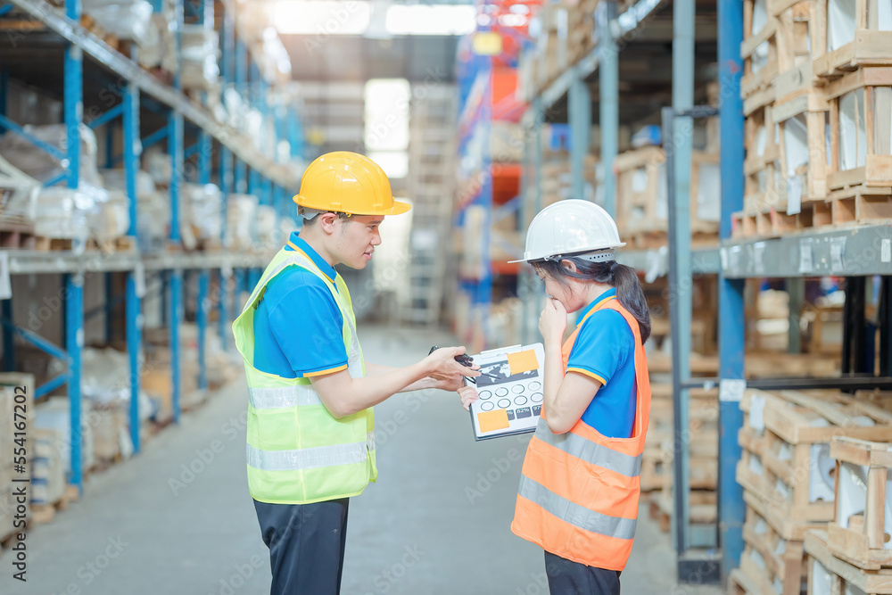 Warehouse worker being scolded and admonished by the supervisor ,Warehouse worker checking packages on shelf in a large store. Warehouse worker being scolded and admonished by the supervisor ,Warehouse worker checking packages on shelf in a large store.