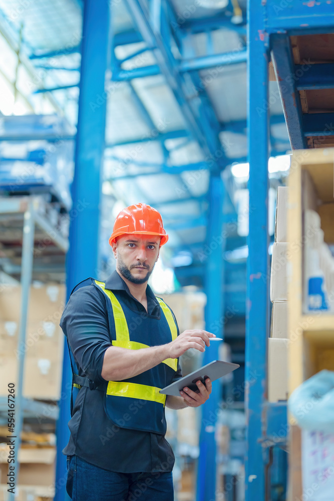 Warehouse workers in helmets checking goods and supplies on shelves with goods background in warehouse worker packing in a large warehouse in a large warehouse. Logistics industry concept. Warehouse workers in helmets checking goods and supplies on shelves with goods background in warehouse worker packing in a large warehouse in a large warehouse. Logistics industry concept.