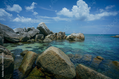 rocks on the beach at dream island when blue sky and cloud