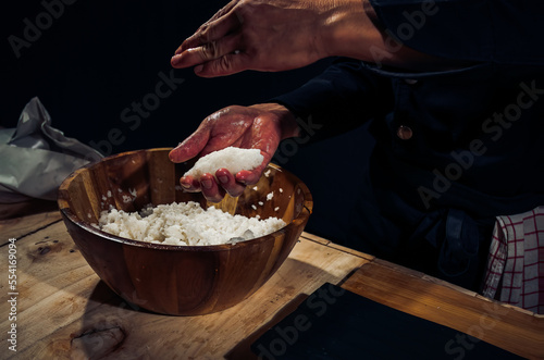 Japanese chef making rice nigiri sushi with tuna, salmon, shrimp,traditional Japanese food ,Dark Tone