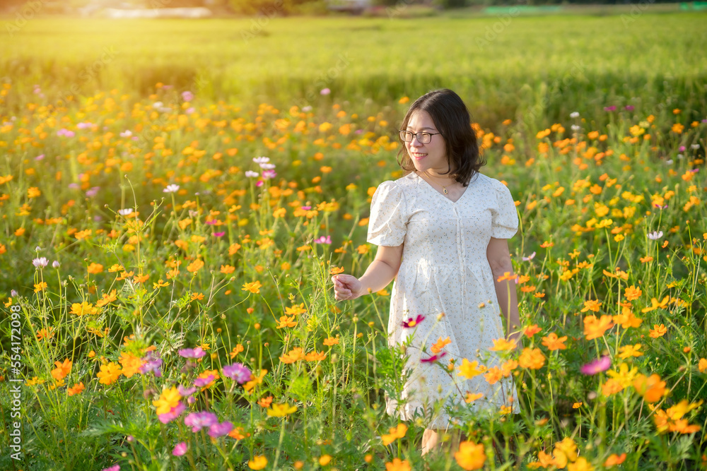 Portrait of asian Young woman happy traveler with white dress enjoying in Yellow and pink sulfur Cosmos flowers blooming field in the nature garden of in Chiang Mai,Thailand,travel relax vacation Portrait of asian Young woman happy traveler with white dress enjoying in Yellow and pink sulfur Cosmos flowers blooming field in the nature garden of in Chiang Mai,Thailand,travel relax vacation
