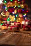 Christmas background. Shallow depth of focus. Colorful bokeh lights, rustic wooden table. Place for typography. 