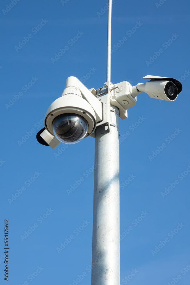 Security cctv cameras on pylon. Surveillance cameras for privacy and protection on blue background