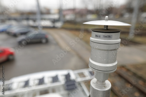 Shallow depth of field (selective focus) details with a PM 10 particle sensor on a heavy traffic street during a rainy day. Air quality concept.