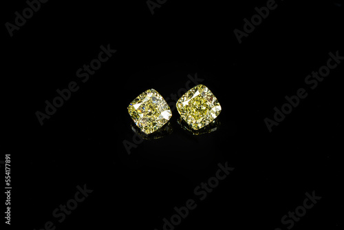 Cushion fancy yellow diamonds on black reflection surface