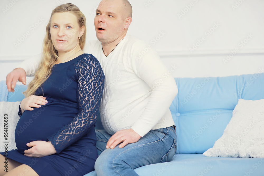 Husband and wife are expecting children. Young family couple pregnancy. A woman with a big belly.