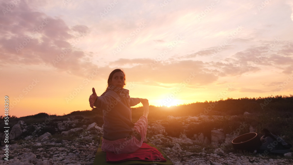 Woman practicing yoga outdoors in sunset sunrise time. Woman practicing yoga outdoors in sunset sunrise time.