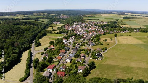 Aerial View Of Waldsolms Village Town In Germany Surrounded By Green Countryside Fields. Dolly Right photo