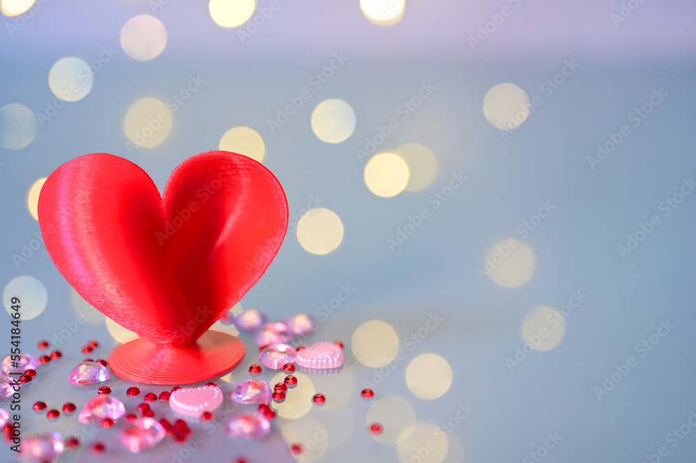 Marriage or Valentins Day heart with sequins on a blue background.