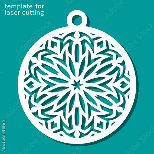 Christmas ball with a carved pattern. Decorative round decoration with snowflake for the New Year. Template for plotter laser cutting of paper, wood carving, metal engraving, cnc. Vector illustration.