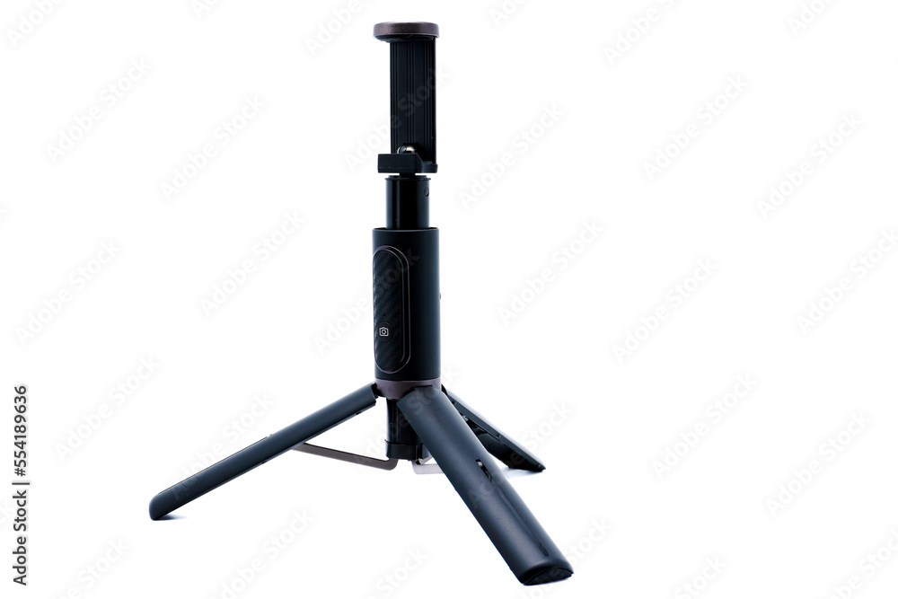 Naklejka premium Black smartphone tripod with wireless remote control isolated on white background.