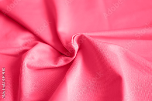 microfiber fabric pink color background with pleats, top view. toned in viva magenta, trend color of the year 2023