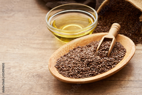 flaxseed linseed and oil in wood bowl on wooden table background. flaxseed linseed oil and bag. flaxseed linseed oil                                                      