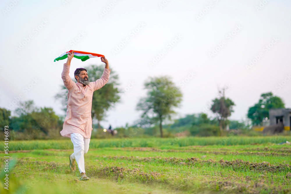 Indian farmer running and waving national flag at agriculture field. Indian farmer running and waving national flag at agriculture field.