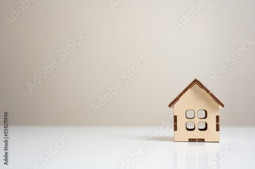 wooden house model on white table. Mini residential craft house. construction, mortgage, real estate. Housing and homeownership cost concept. purchase and sale of housing. copy space