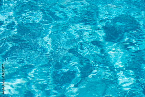 Ripped water in swimming pool. Surface of blue swimming pool  background of water.