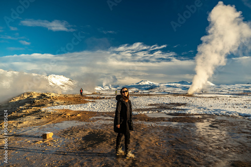 young woman smiling and watching in camera at hverir geothermal fumarole