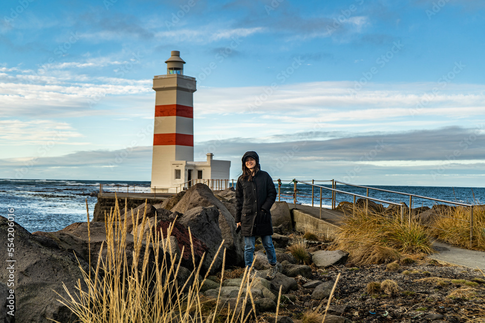 young woman at Garður Old Lighthouse, iceland