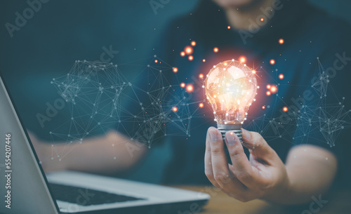 Concept Innovation, inspiration, creative solution idea for modern business intelligence technology. Success creativity invention, thinking imagination digital marketing online. Hand hold light blub.