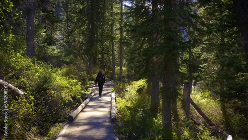Tourist walks on the Jenny Lake Trail in Grand Teton National Park, Wyoming