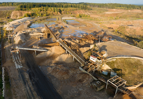 Sand Making Plant and Belt conveyor in mining quarry. Gold mining in opencast.  Sand crushing and bulk materials for construction industry. Open-pit mining. Ore mine.