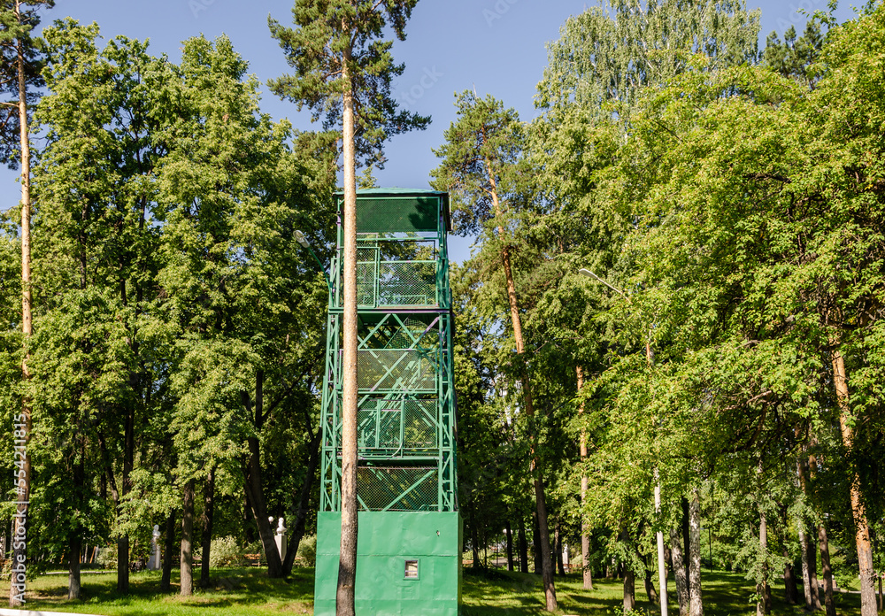 A high observation tower in the forest on a summer day. A high observation tower in the forest on a summer day.