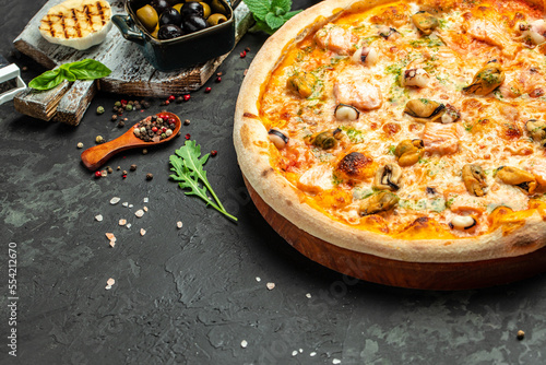 pizza with seafood on a dark background  banner  menu  recipe place for text  top view