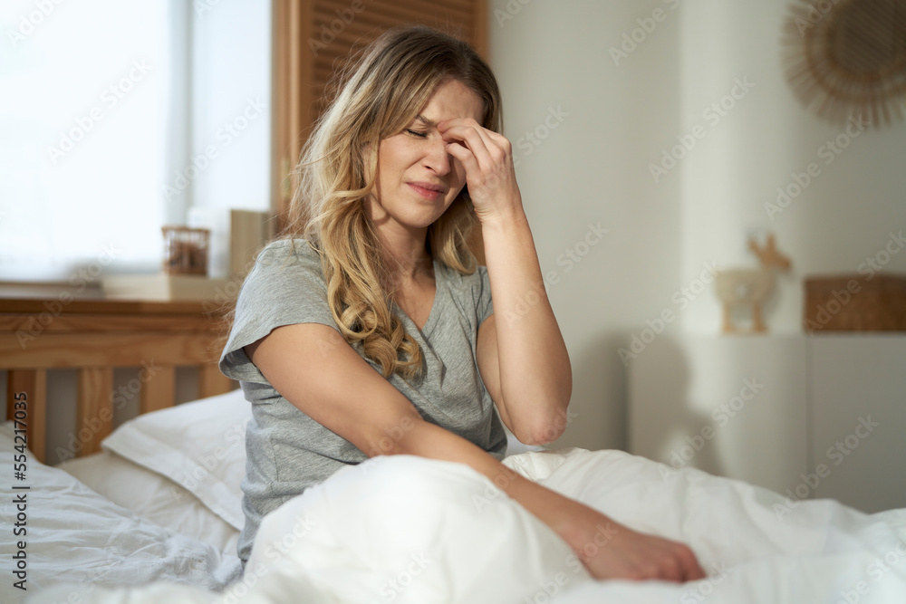 Caucasian woman with grimacing face suffering with pain of sinus Caucasian woman with grimacing face suffering with pain of sinus