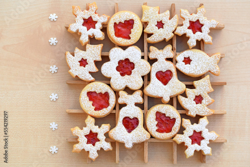 Various shapes of Linzer cookies filled with strawberry jam. Christmas baking