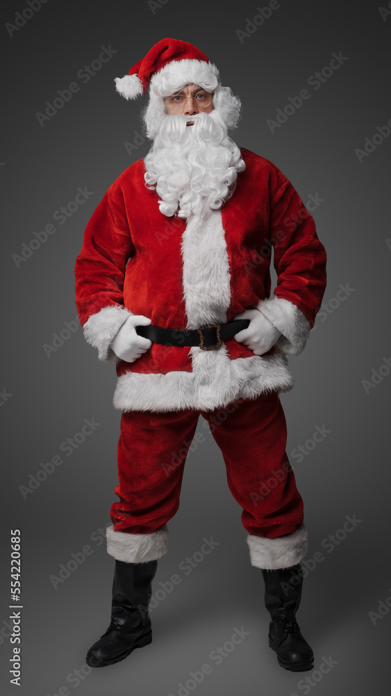 Studio shot of cheerful elderly santa dressed in red winter costume. Studio shot of cheerful elderly santa dressed in red winter costume.