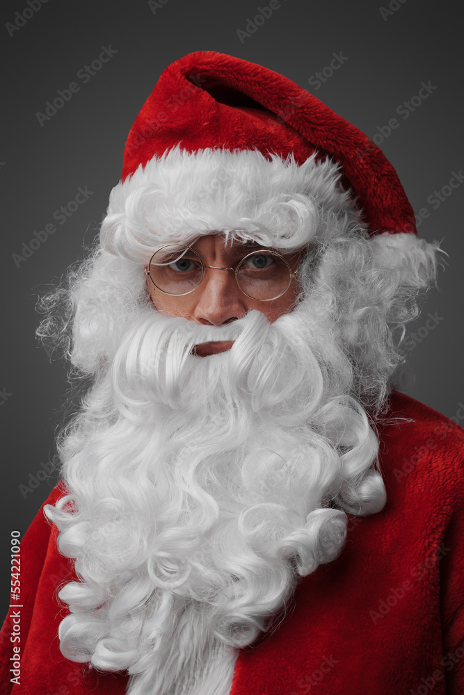 Headshot of santa claus with long beard and red costume isolated on grey.