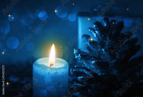Blue Advent candle and decoration isolated on blur background.