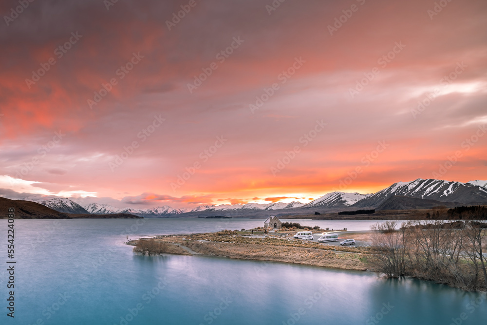Sunrise view of the Church Of Good Shepherd in late winter with beautiful snow capped Southern Alps mountain range in the background. Lake Tekapo, Canterbury, New Zealand South Island.
