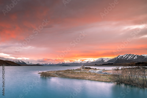 Sunrise view of the Church Of Good Shepherd in late winter with beautiful snow capped Southern Alps mountain range in the background. Lake Tekapo, Canterbury, New Zealand South Island.