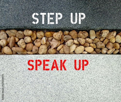 Walk way in garden with text written STEP UP, SPEAK UP, concept of express opinions frankly openly and freely, to raise voice to defend something rather than remain silent