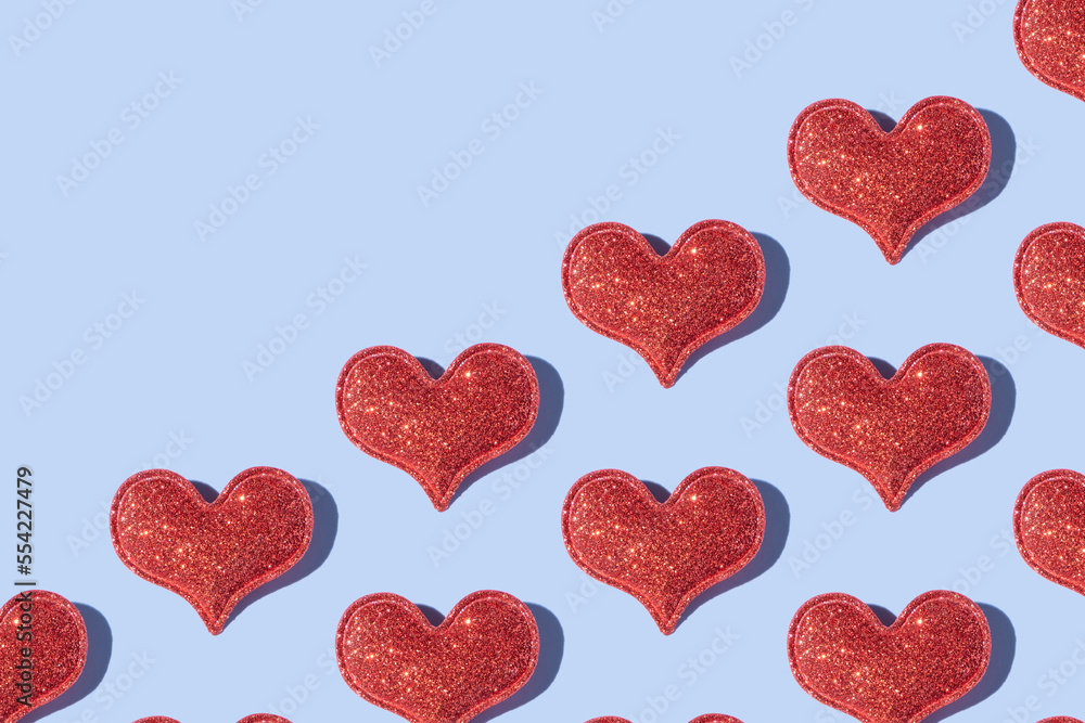 Pattern made from glitter heart shape on colored background with hard shadow. Valentines day minimalistic design Pattern made from glitter heart shape on colored background with hard shadow. Valentines day minimalistic design