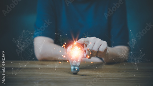 Hand on light blub. Concept Innovation, inspiration, creative solution idea for modern business intelligence technology. Success creativity invention, thinking imagination digital marketing online.