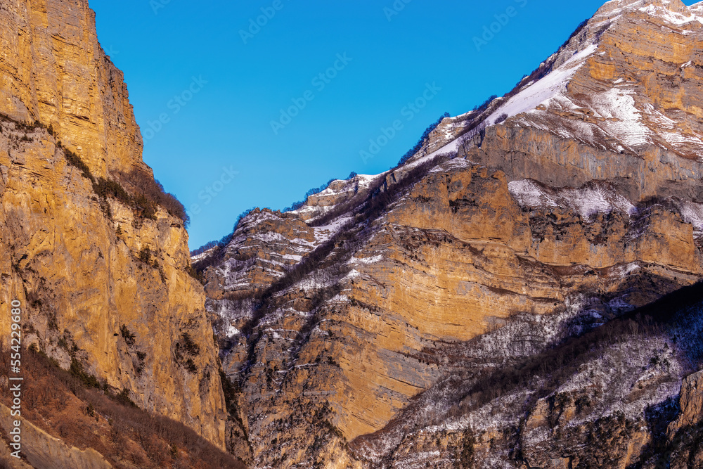 Obraz premium Beautiful Mountain Landscape. Panoramic view of the snow-covered winter mountains of the Greater North Caucasus. Elbrus, Upper Balkaria, Kabardino-Balkaria, Russia.