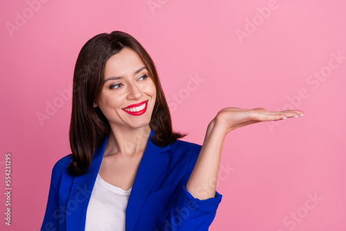 Closeup photo of young attractive businesswoman toothy beaming smile hold palm object best price offer sale isolated on pink color background